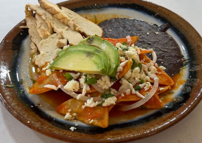 Chilaquiles with slices of roast pork at zandoyo bed & breakfast